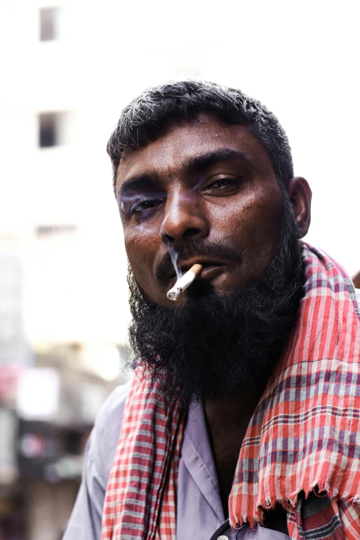 a man with a beard smoking a cigarette, an album cover, pexels contest winner, hurufiyya, old dhaka, bruised face, lgbtq, beaten