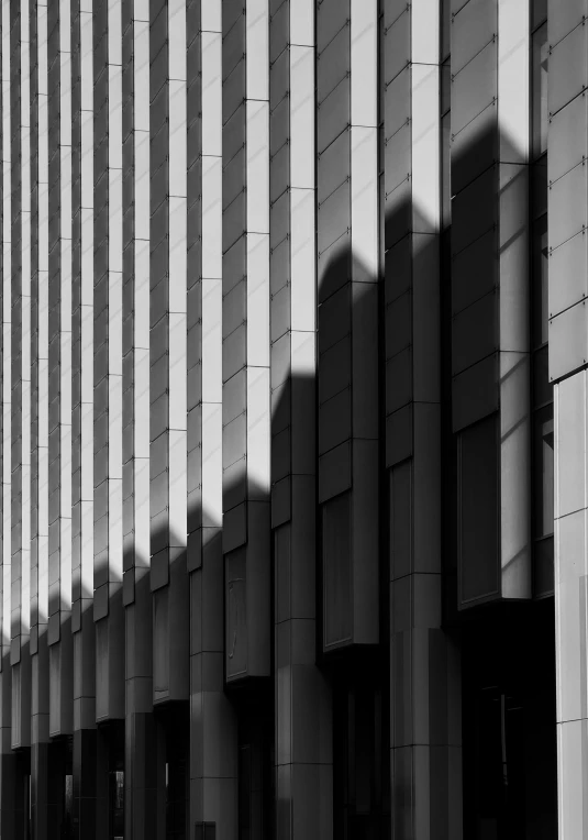 a black and white photo of a building, inspired by David Chipperfield, unsplash contest winner, deep shadows and colors, sunshafts, abstract facades of buildings, square lines