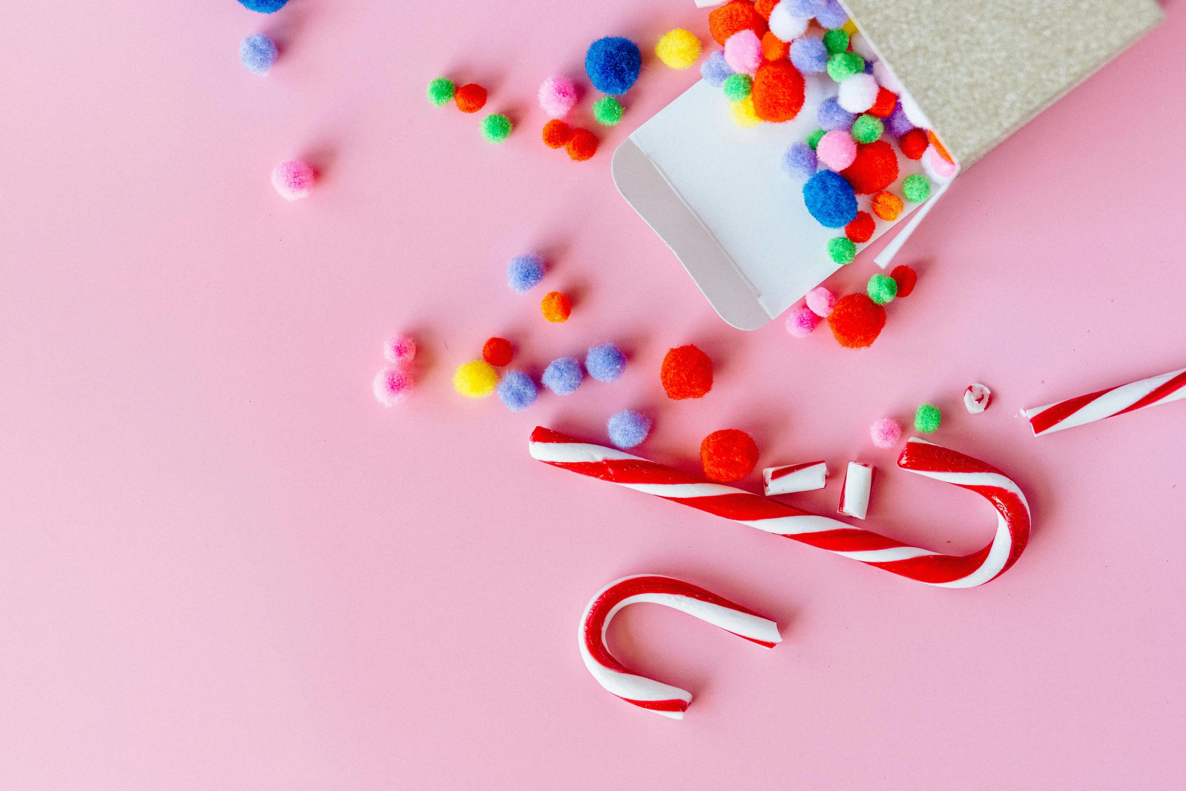 a candy cane sitting on top of a pink surface, various items, thumbnail, gumdrops, santa's workshop