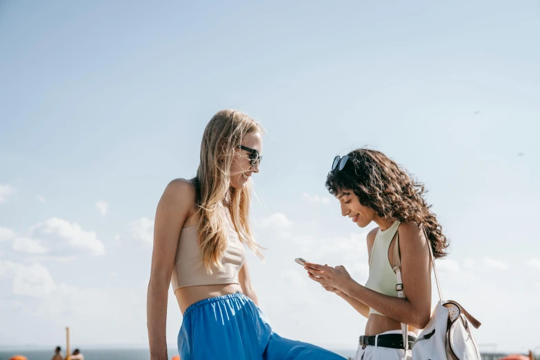 two women standing next to each other on a beach, trending on pexels, happening, girl making a phone call, sydney sweeney, on a rooftop, avatar image