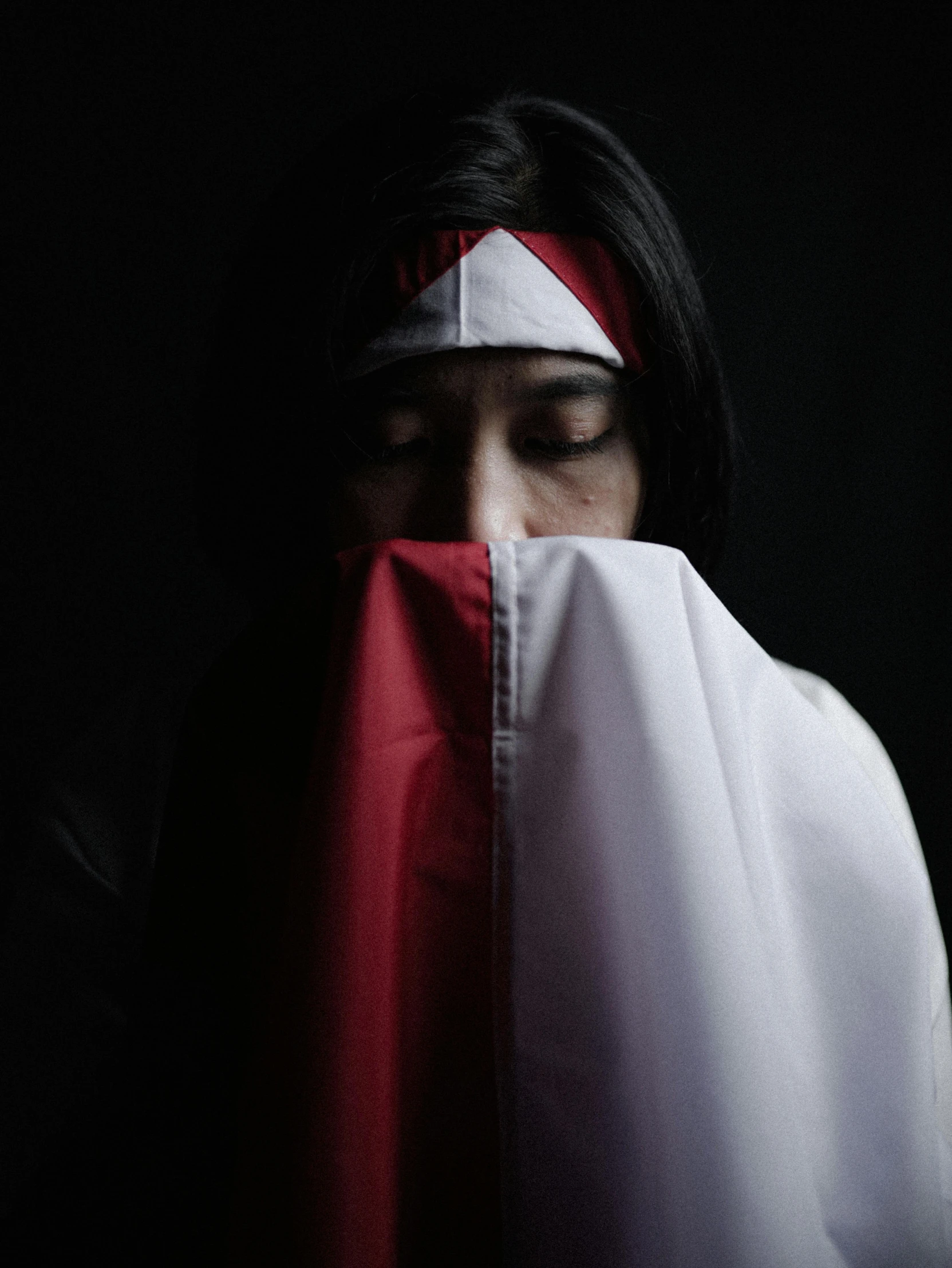 a woman with a red scarf covering her face, an album cover, inspired by Sasha Putrya, unsplash, hurufiyya, holding a white flag, jakarta, ((portrait)), dark and white