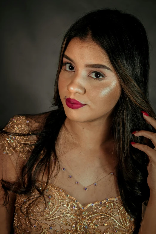 a woman in a gold dress posing for a picture, by reyna rochin, close-up shoot, 18 years old, portrait 8 k, violet myers