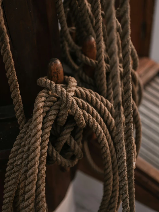 a close up of a bunch of rope on a boat, an album cover, by Jacob de Heusch, trending on unsplash, renaissance, wooden supports, ignant, high details photo, ( 3 1
