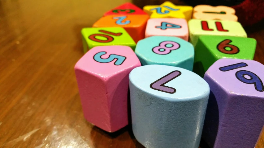 a pile of wooden blocks with numbers on them, a picture, by Alexander Brook, colourful pastel, six sided, shot on sony a 7, square