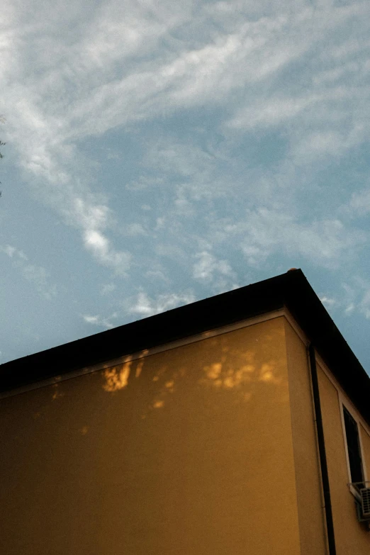 a man flying through the air while riding a skateboard, unsplash, postminimalism, bonsai tree on roof, late summer evening, today\'s featured photograph 4k, yellow clouds