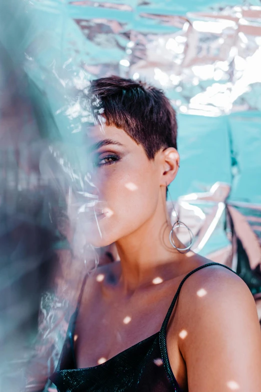 a woman standing under an umbrella in the rain, an album cover, trending on pexels, pixie cut, smoking outside, sunny light, profile image