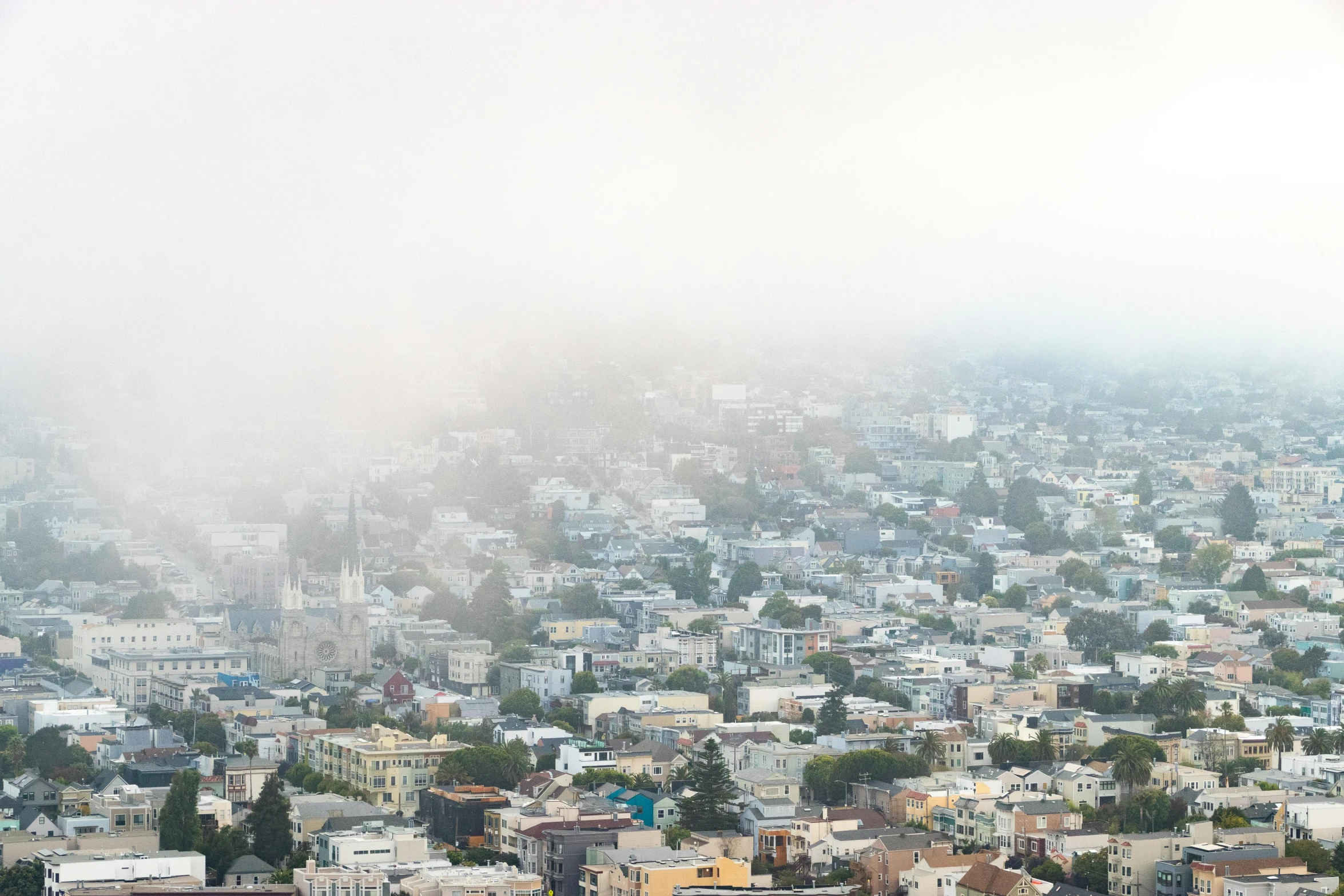 a view of a city on a foggy day, by Carey Morris, unsplash contest winner, renaissance, hillside, background image, hyperdetailed photo, heat haze