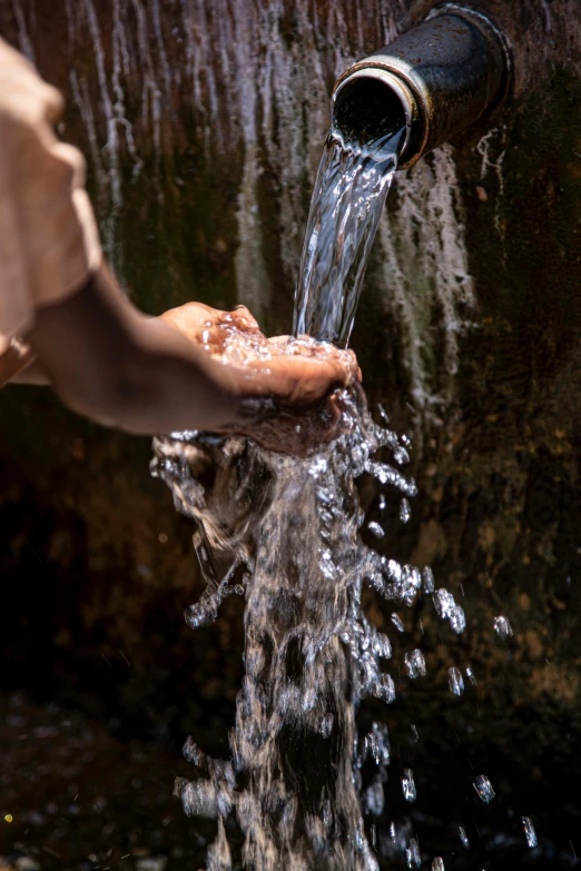 a person is pouring water from a pipe, by david rubín, afar, wet shiny skin, no cropping, environment