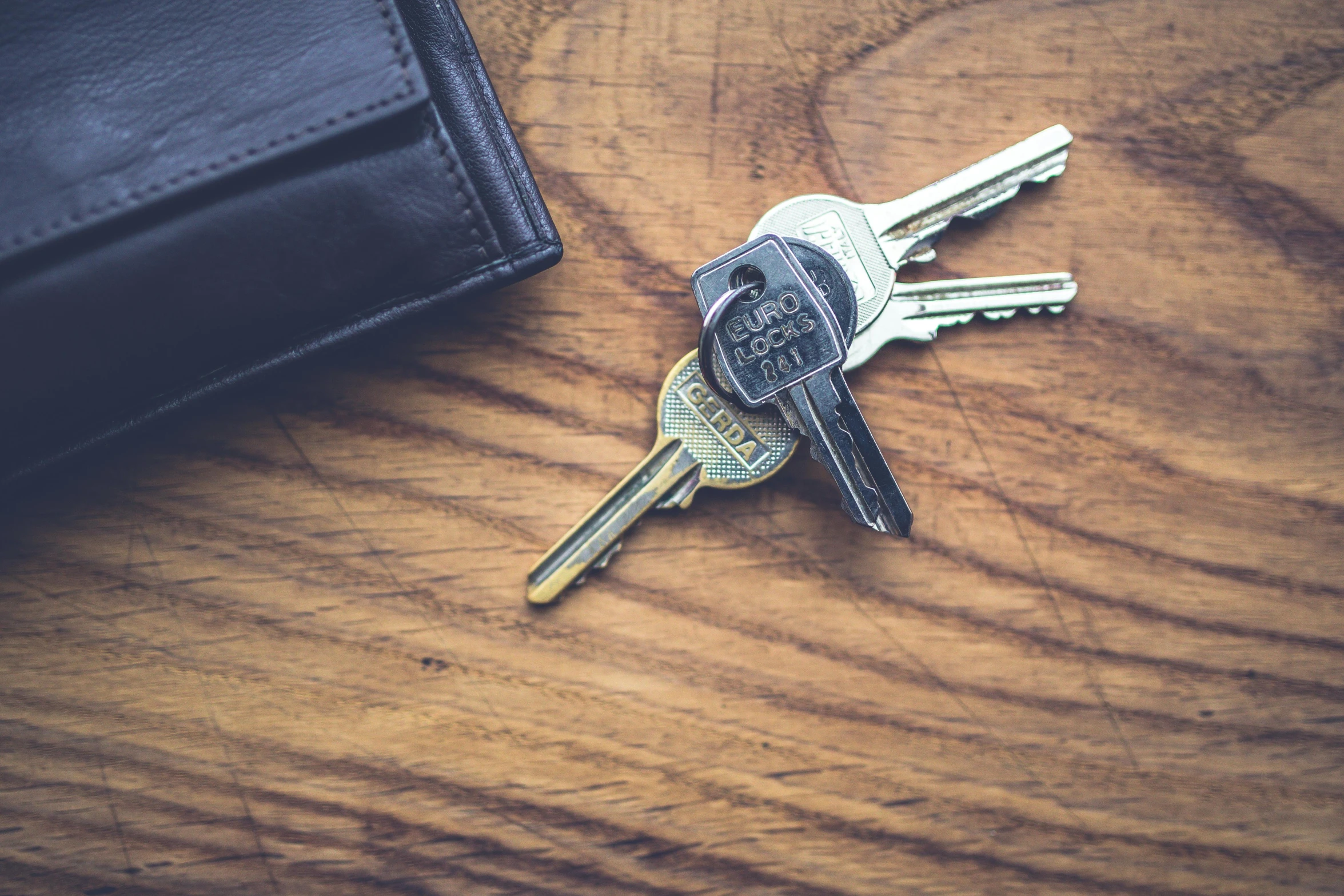 a bunch of keys sitting on top of a wooden table, pexels, avatar image, handheld, multiple stories, profile image