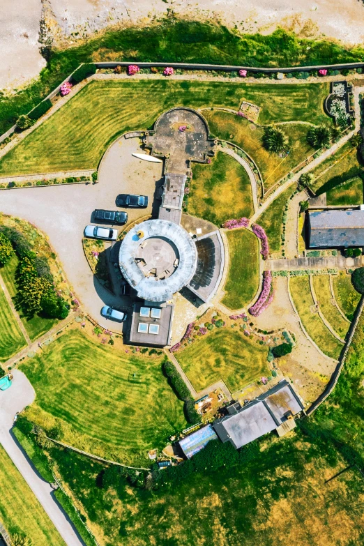 a bird's eye view of an aerial view of a park, unsplash, land art, in the middle of round ruins, helipad, cornwall, nuclear reactor