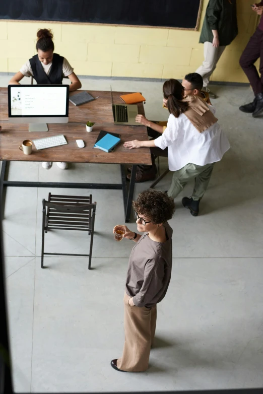 a group of people sitting around a table with laptops, trending on pexels, renaissance, standing on a desk, brown, square, sustainable materials