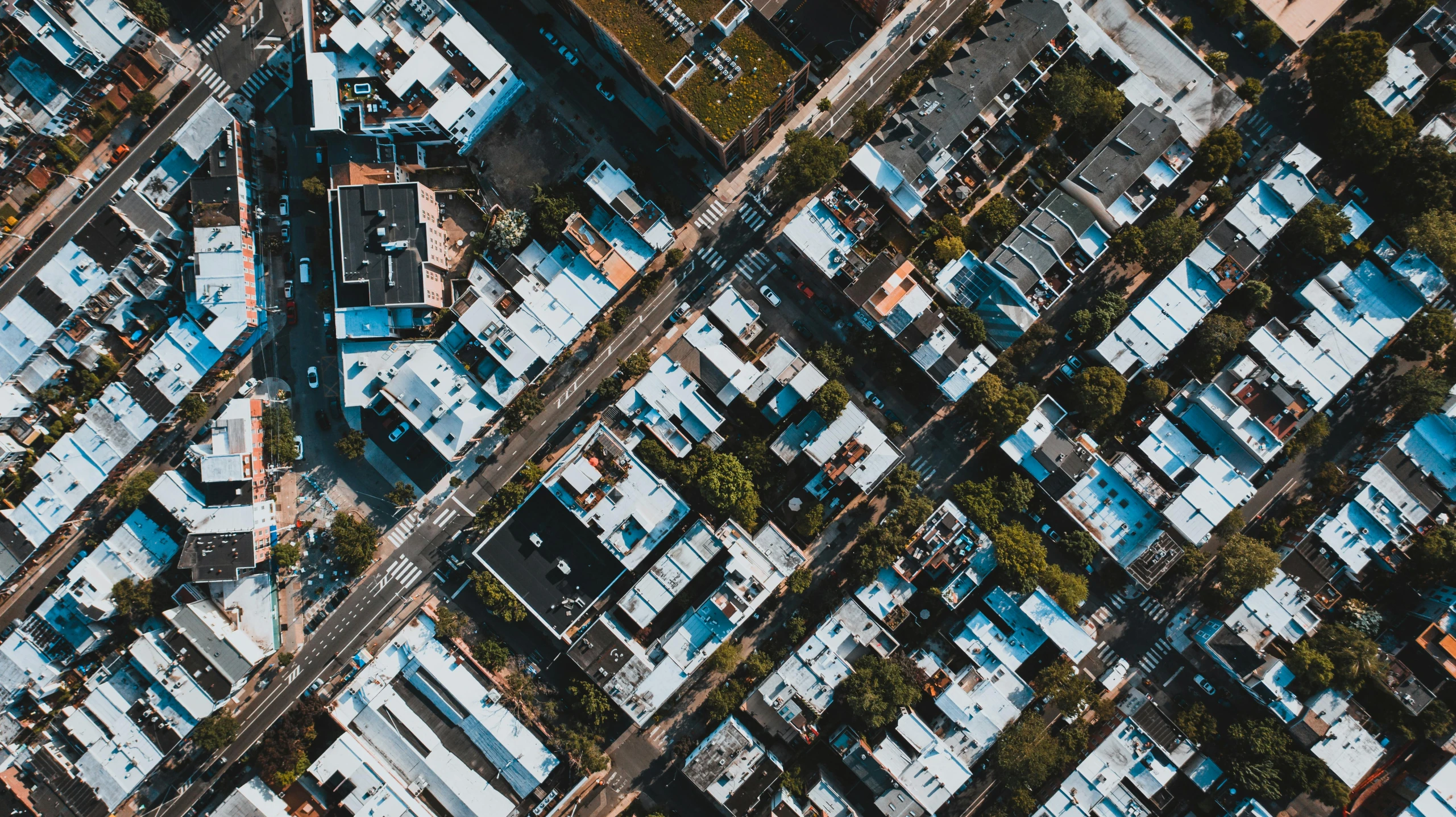 an aerial view of a city with lots of buildings, by Carey Morris, unsplash contest winner, realism, sharp roofs, high - contrast, suburbs, angled shot