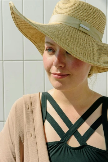a close up of a person wearing a hat, nina tryggvadottir, summer weather, decolletage, wearing a simple robe