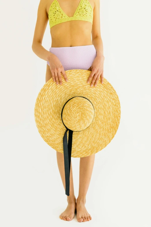 a woman in a bikini and a straw hat, by Nicolette Macnamara, unsplash, renaissance, on a pale background, yellow purple, 165 cm tall, round-cropped