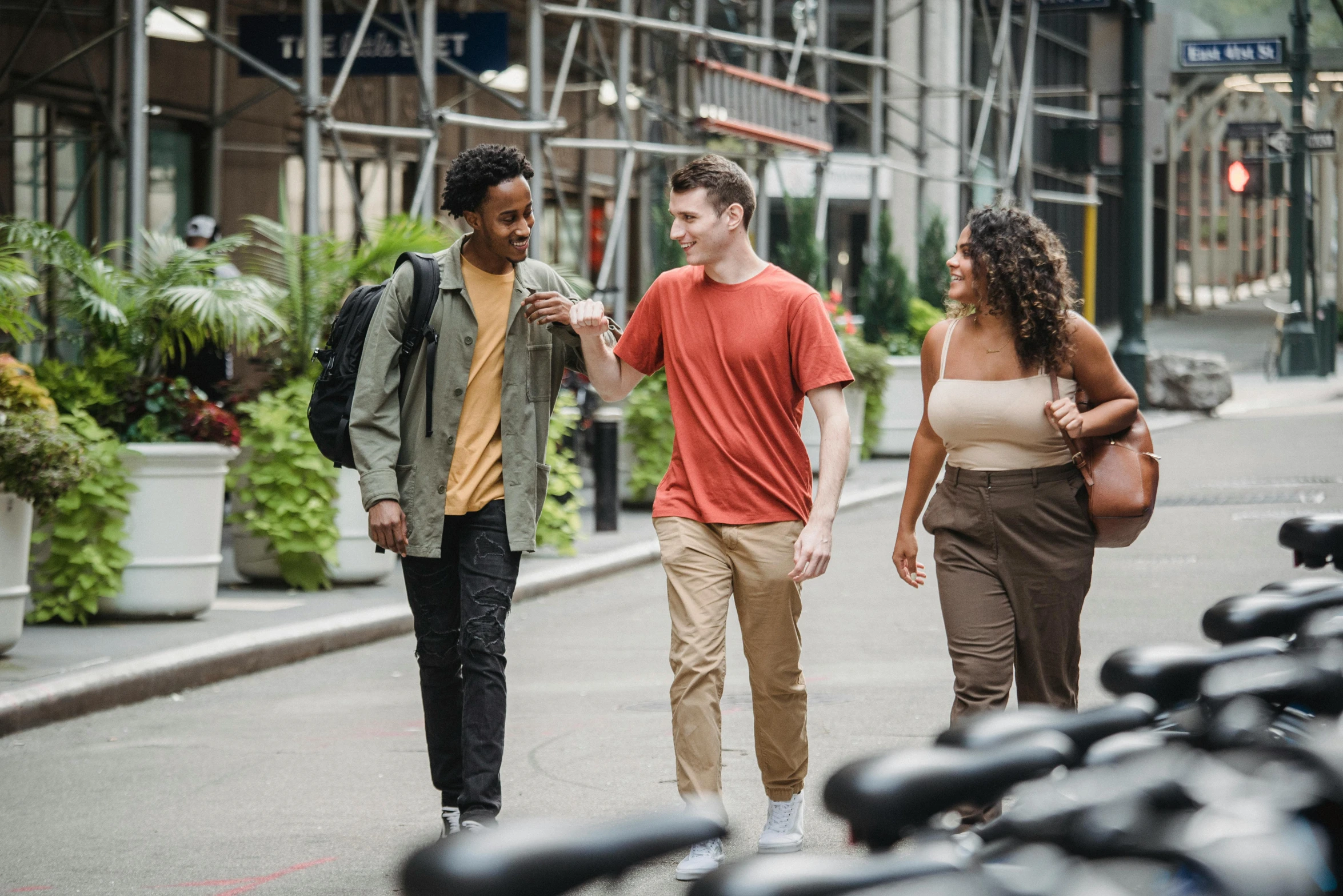 a group of people walking down a street, diverse, background image, ignant, college