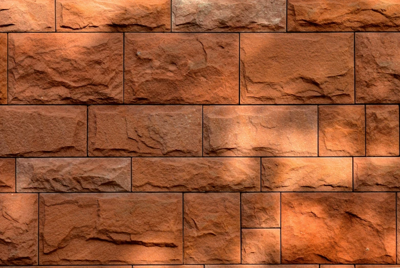 a fire hydrant sitting in front of a brick wall, a digital rendering, inspired by Nyuju Stumpy Brown, stylized stone cladding texture, red sandstone natural sculptures, photo - realistic wallpaper, reddish - brown