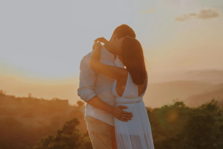 a man and a woman standing next to each other, pexels contest winner, romanticism, sun drenched, making out, in a scenic background, white