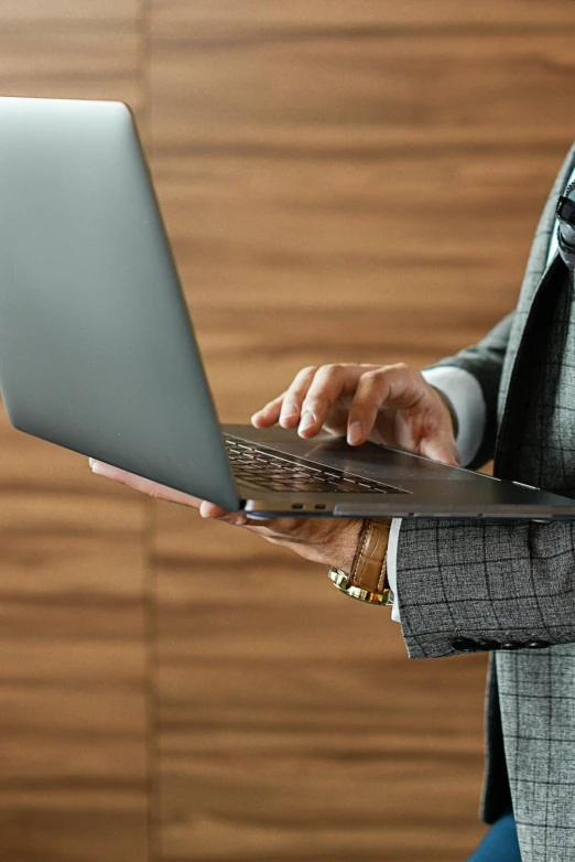 a close up of a person using a laptop, wearing a blazer, laptops, standing straight, multiple stories