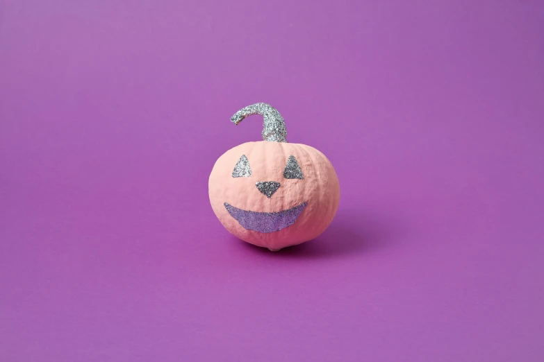 a pumpkin sitting on top of a purple surface, paper decoration, textured base ; product photos, small upturned nose, pink