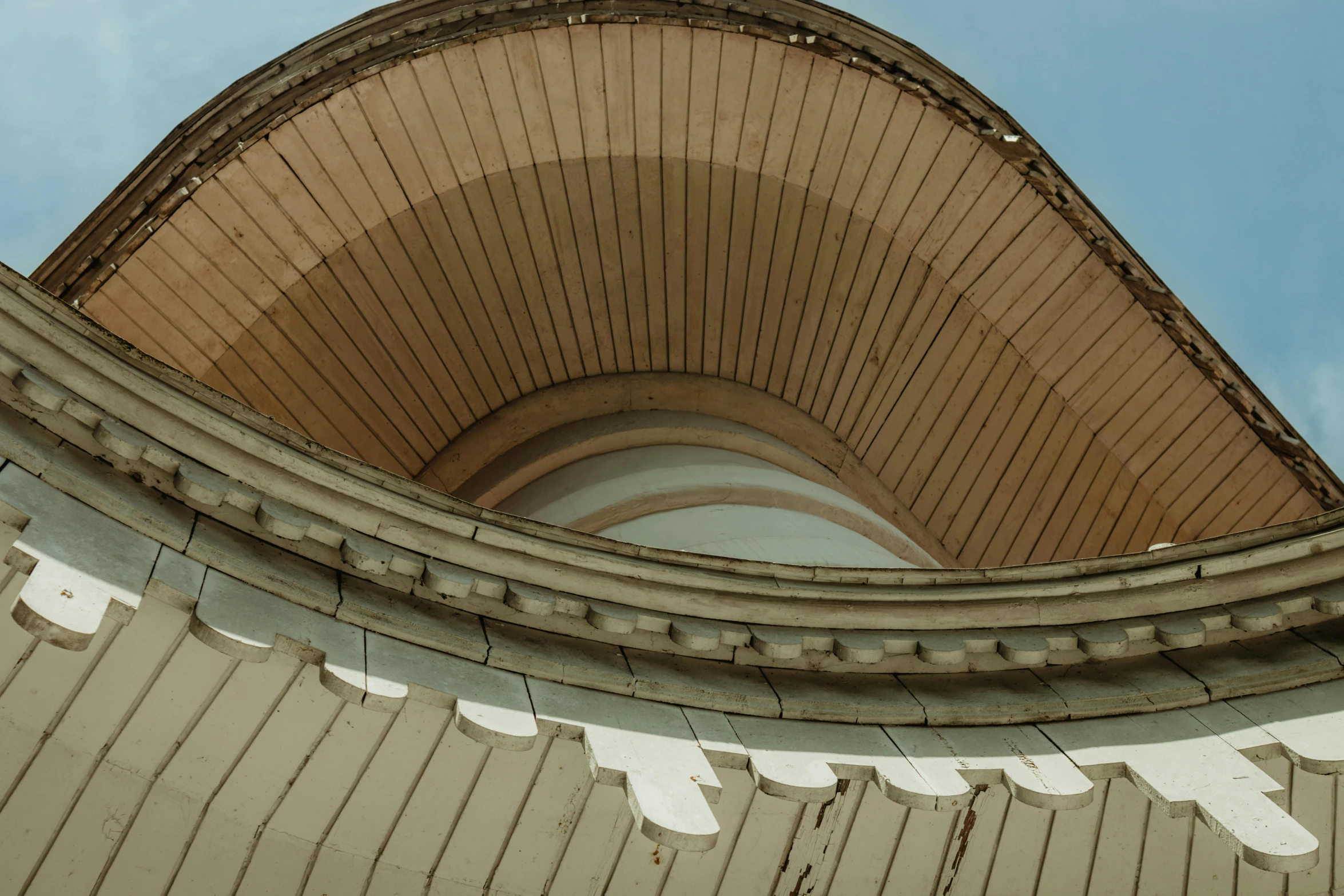 a clock that is on the side of a building, an album cover, by Attila Meszlenyi, unsplash contest winner, berlin secession, curving geometric arches, bottom - view, brown, lead - covered spire