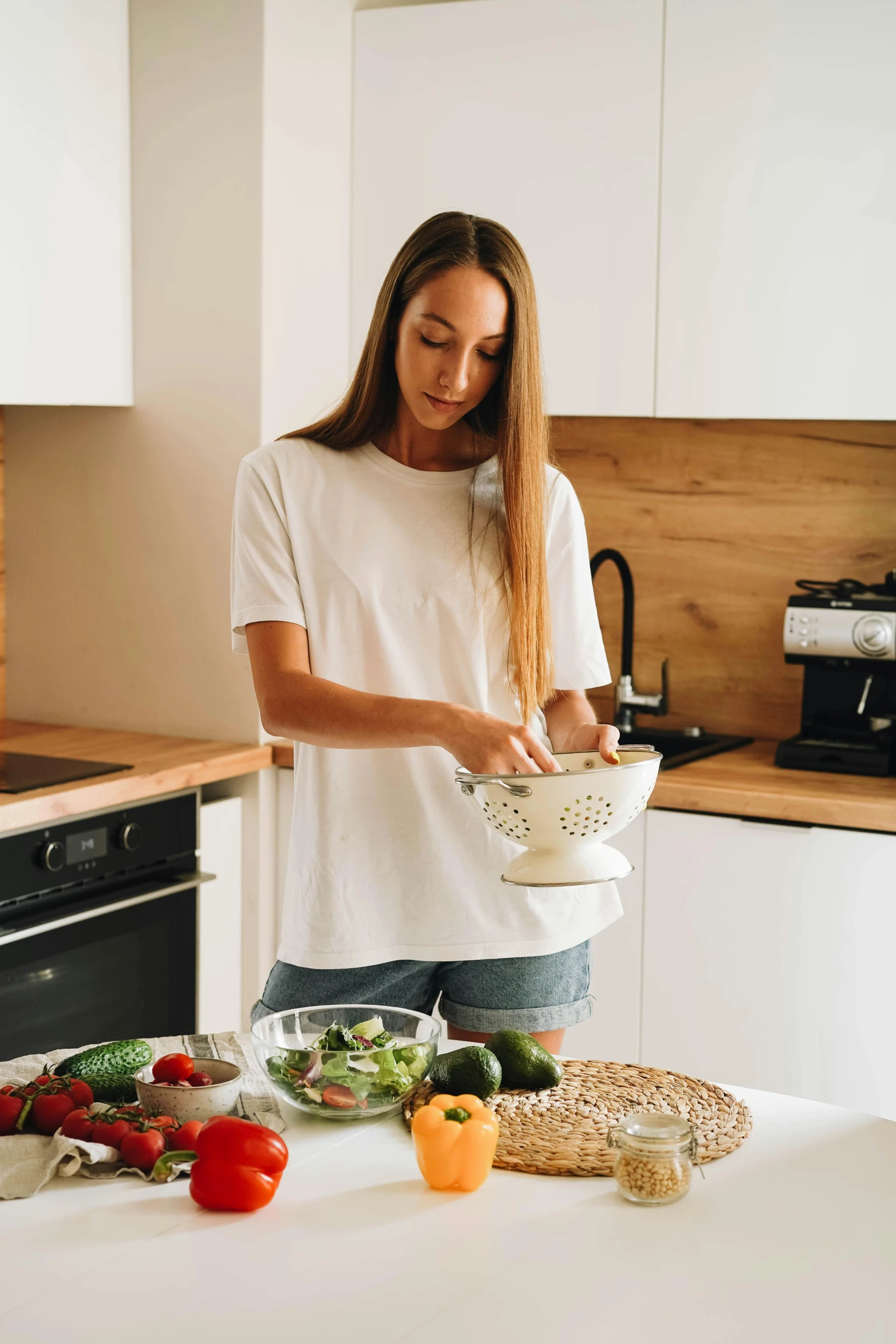 a woman standing in a kitchen preparing food, pexels contest winner, dressed in a white t shirt, bowl, australian, gif