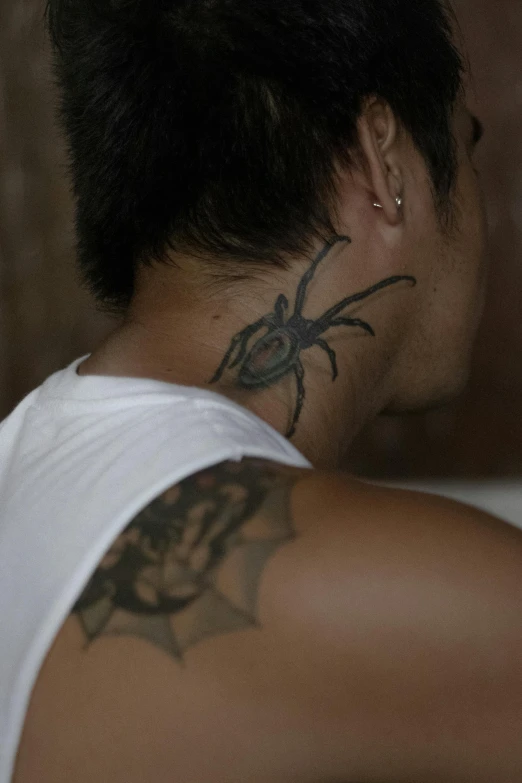 a man with a spider tattoo on his back, reddit, sumatraism, medium head to shoulder shot, digital image, malaysian, sleeveless