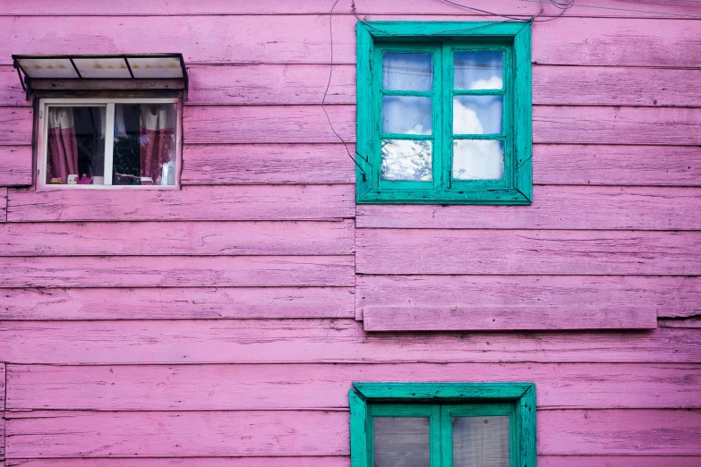 a red fire hydrant sitting in front of a pink building, an album cover, inspired by Elsa Bleda, maximalism, wooden house, many large green windows, patagonian, photo of a beautiful window