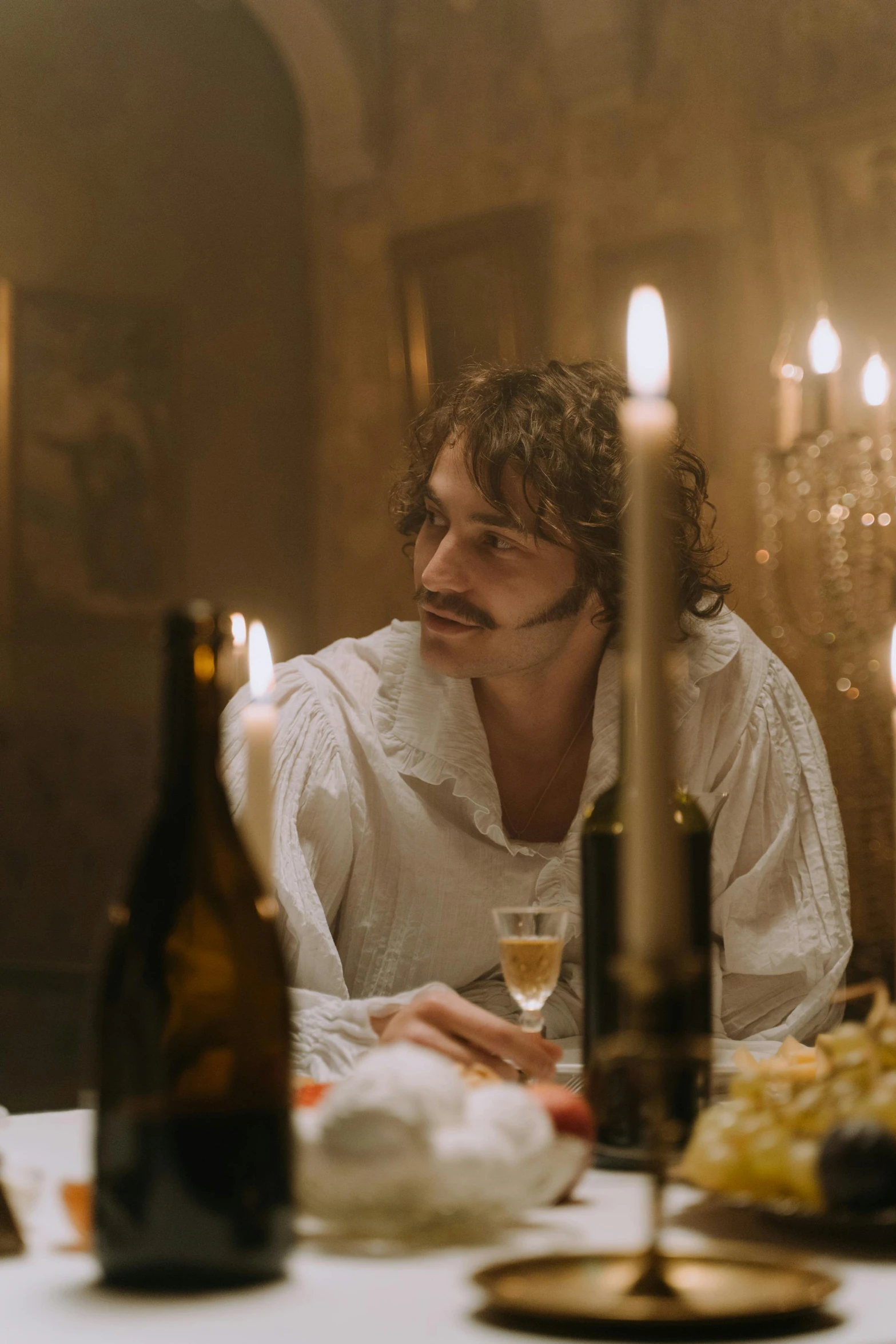 a man sitting at a table with a glass of wine, inspired by Karl Bryullov, shutterstock, rococo, perfectly lit. movie still, romantic lead, herry cavill, timothee chalamet