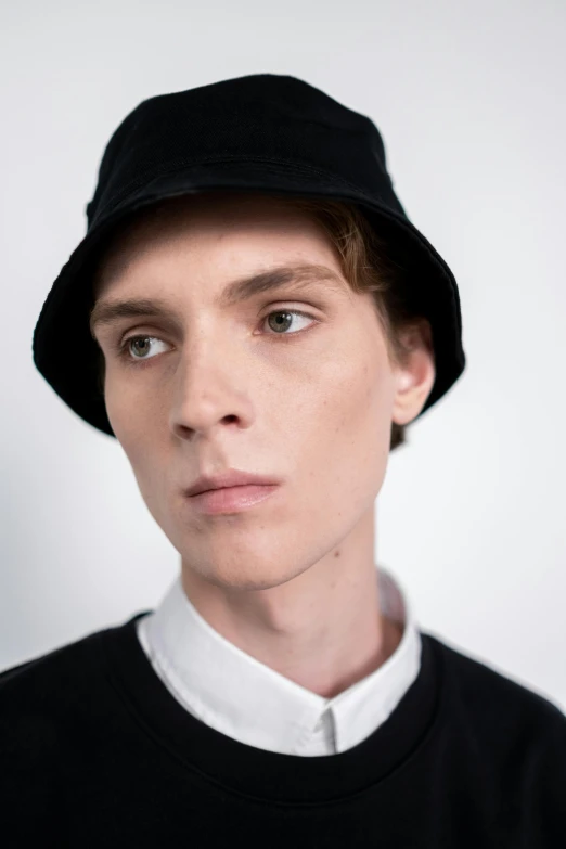 a close up of a person wearing a hat, inspired by Jean Malouel, well-groomed model, wearing a black shirt, sophia lillis, full product shot