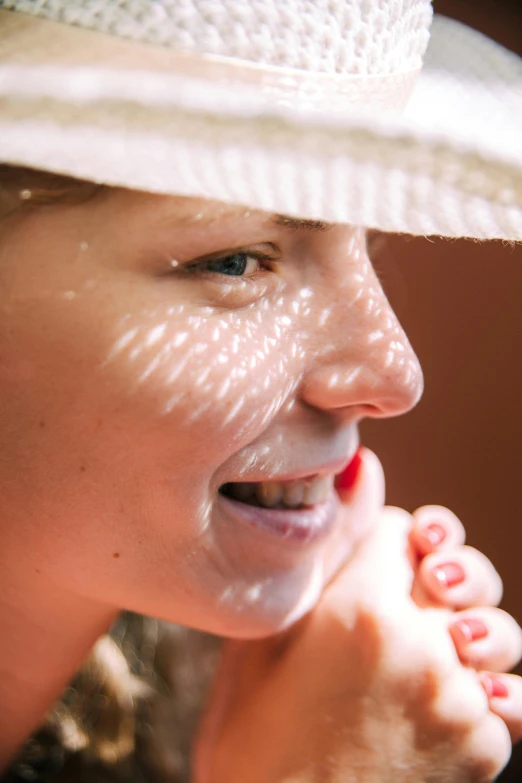 a close up of a person wearing a hat, sunbathed skin, her face is coated in a white, detailed focused