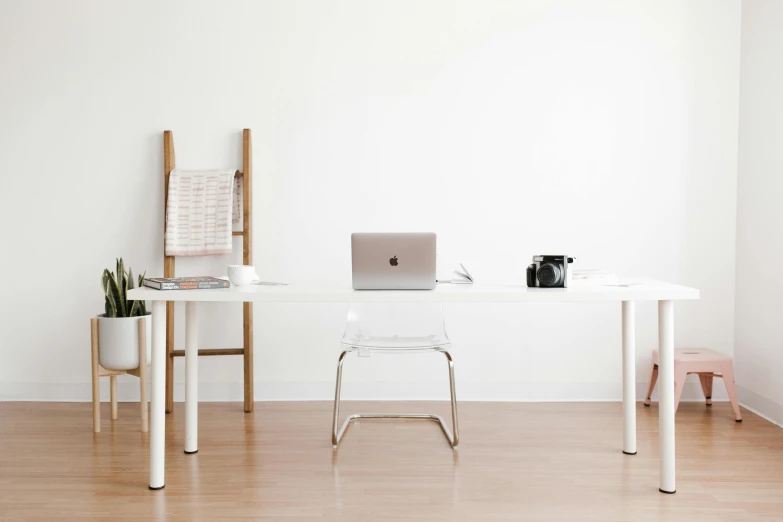 a laptop computer sitting on top of a white desk, pexels contest winner, minimalism, long table, furnished room, cupertino, threes