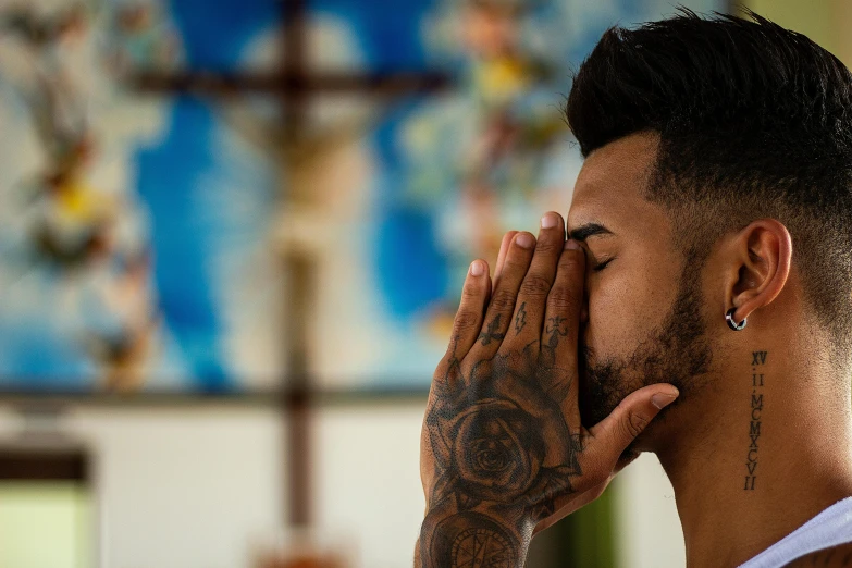 a man with tattoos covering his face with his hands, a photo, pexels contest winner, symbolism, jesus christ in mass effect, neymar jr, looking partly to the left, profile image