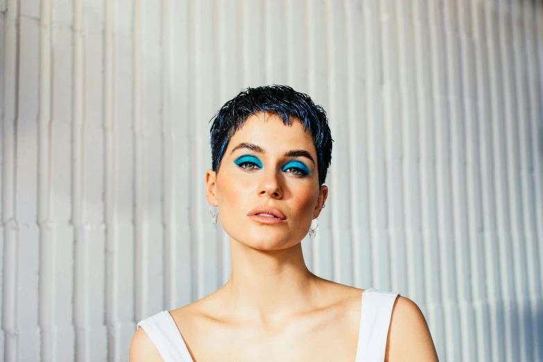 a woman with blue eyes is posing for a picture, an album cover, inspired by Elsa Bleda, trending on pexels, hurufiyya, pixie haircut wlop, christina kritkou, turqouise, beauty campaign