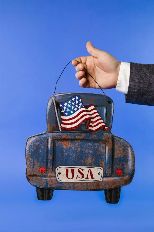 a person holding an american flag in the back of a car, an album cover, by Allen Jones, shutterstock contest winner, toys, metal art, state of the union, 15081959 21121991 01012000 4k