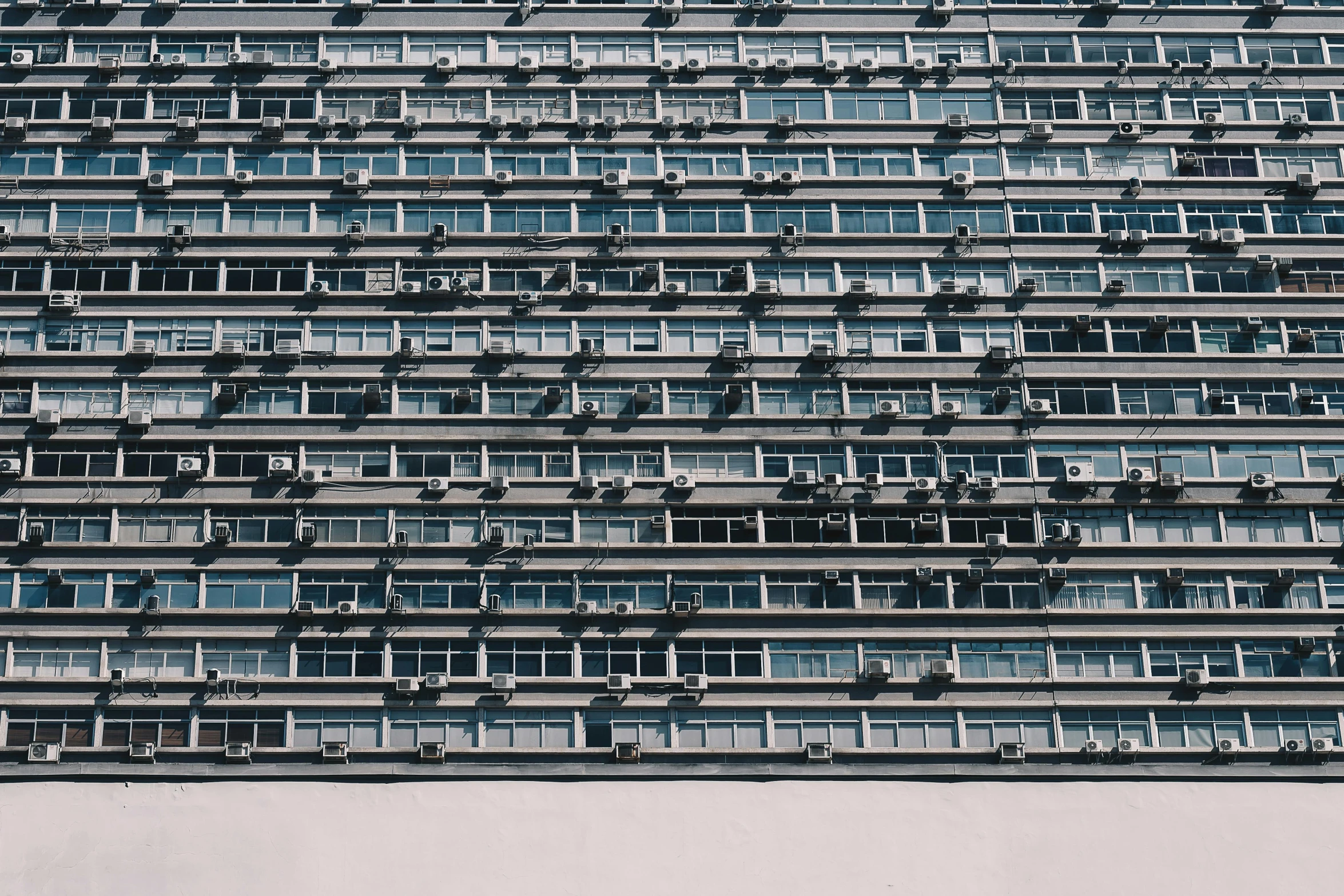 a very tall building with lots of windows, by Adam Rex, pexels contest winner, brutalism, air conditioner, dieter rams, computer wallpaper