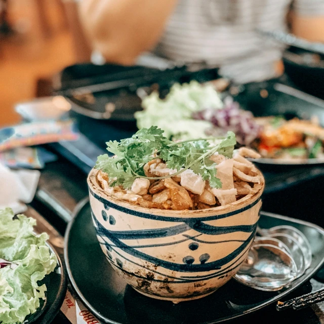 a bowl of food sitting on top of a table, pexels contest winner, mingei, 🤬 🤮 💕 🎀, busy restaurant, avatar image, restaurant menu photo