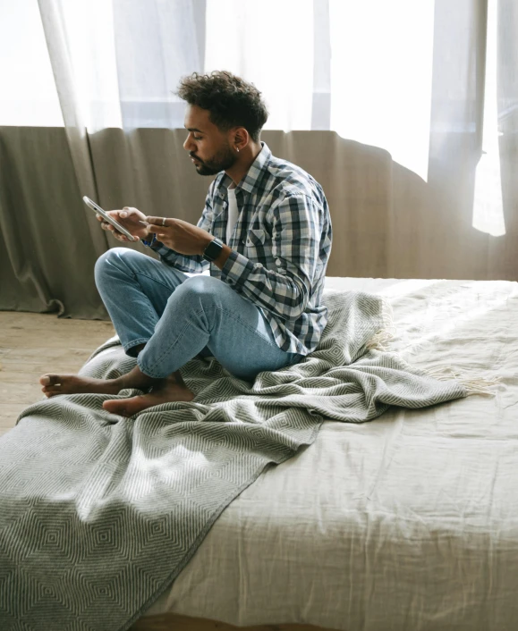 a man sitting on a bed reading a book, trending on pexels, happening, lgbtq, grey, ashteroth, wide full body