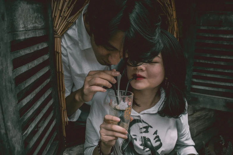 a man and a woman sharing a glass of wine, a picture, pexels contest winner, asian girl, with a straw, post grunge, milk