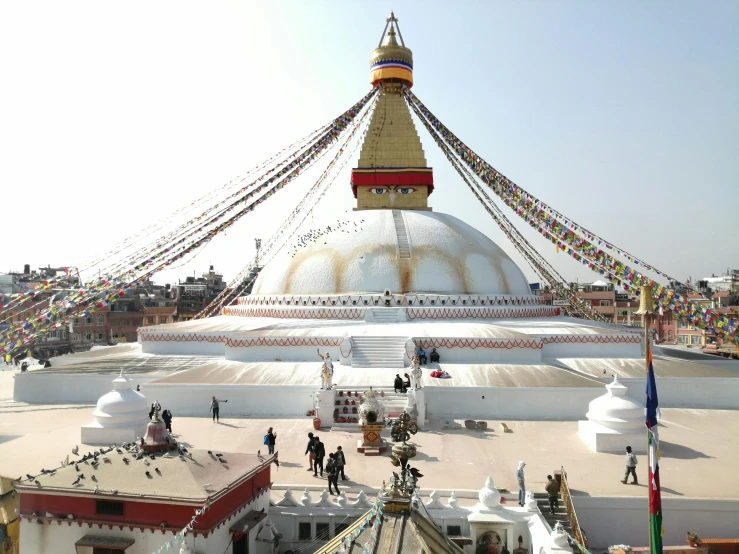 a group of people walking around a large white building, buddhist architecture, avatar image