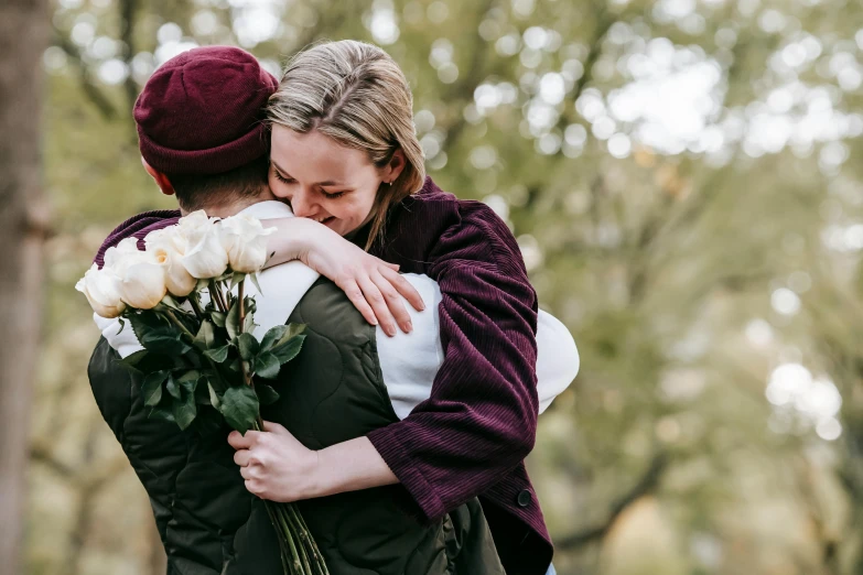 a couple of people that are hugging each other, pexels contest winner, romanticism, carrying flowers, non-binary, heartbroken, instagram post