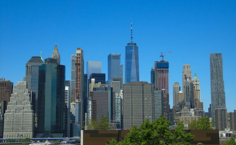 a view of a city with skyscrapers in the background, manhatten on top of skyscrapers, slide show, 2 0 2 2 photo, sunny day time