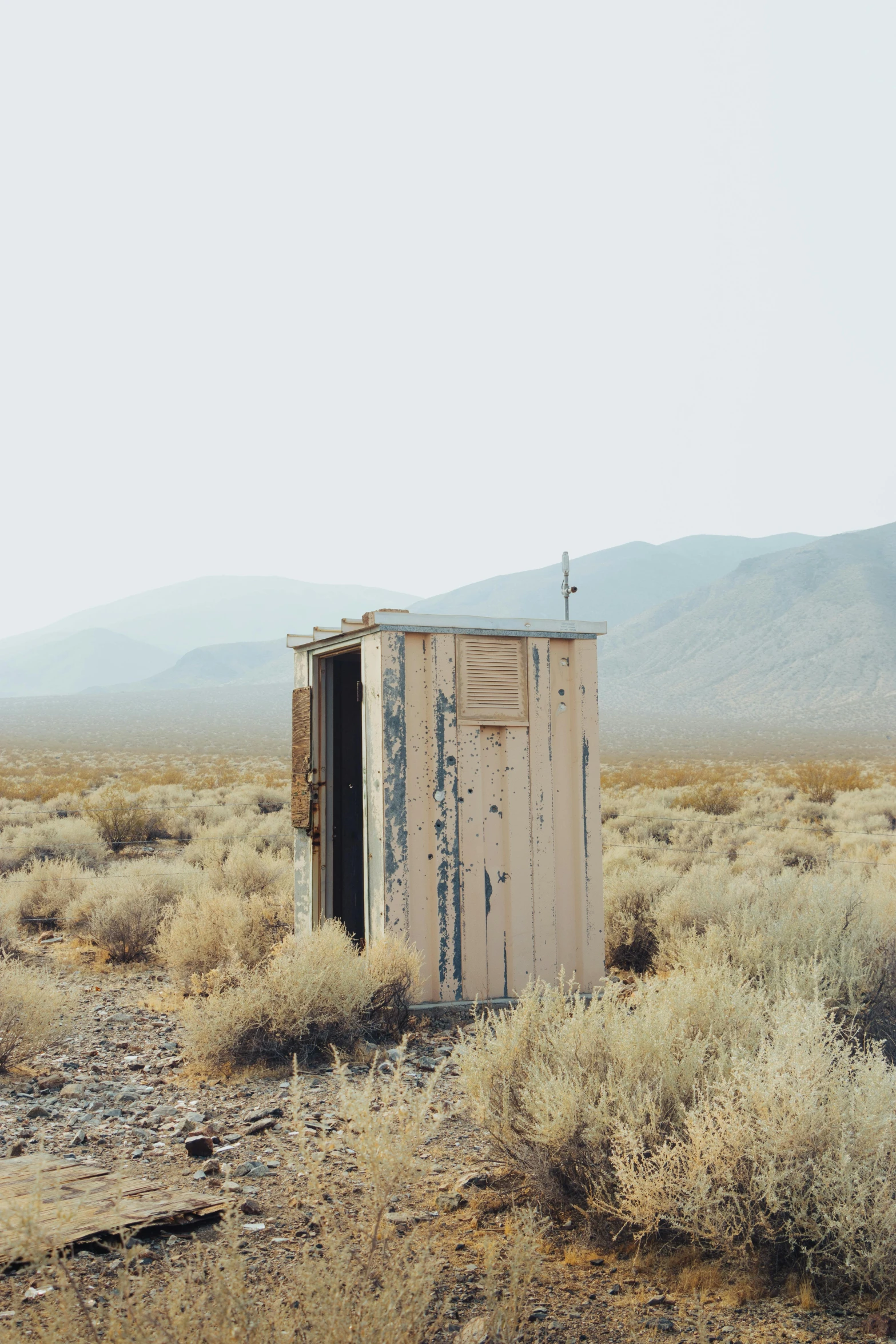 an outhouse in the middle of the desert, by Jessie Algie, unsplash, conceptual art, square, rinko kawauchi, vintage photo, tiny house