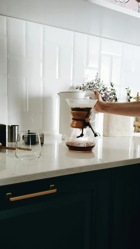 a woman preparing a cup of coffee in a kitchen, by Robbie Trevino, copper details, with clear glass, soma, 8 l