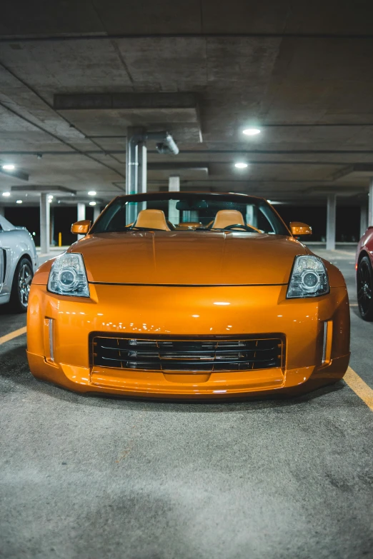 two sports cars parked in a parking garage, by Jason Felix, pexels contest winner, orange hue, front of car angle, samurai vinyl wrap, 15081959 21121991 01012000 4k