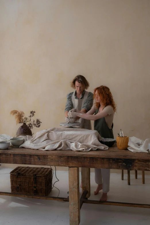 a couple of people that are sitting on a table, by Elizabeth Polunin, process art, creating a soft, chef table, ochre, bedhead