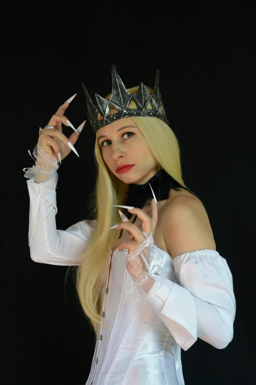 a woman in a white dress with a crown on her head, inspired by Master of the Legend of Saint Lucy, featured on reddit, emma frost, low quality photo, long fingernails, high quality photo