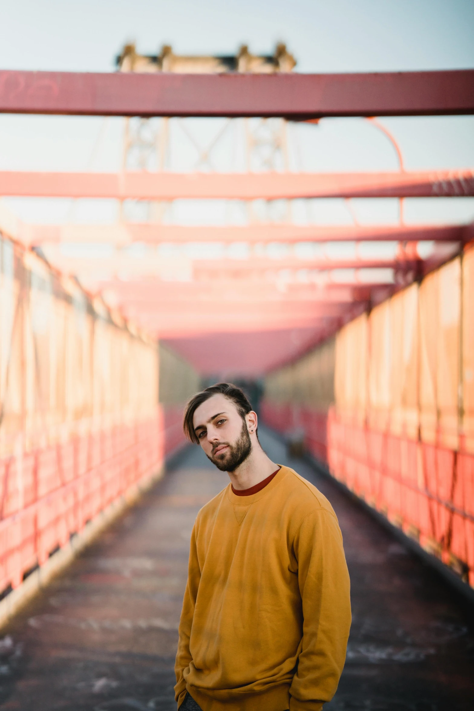 a man standing in the middle of a bridge, an album cover, pexels contest winner, yellow carpeted, borja, halfbody headshot, sunfaded