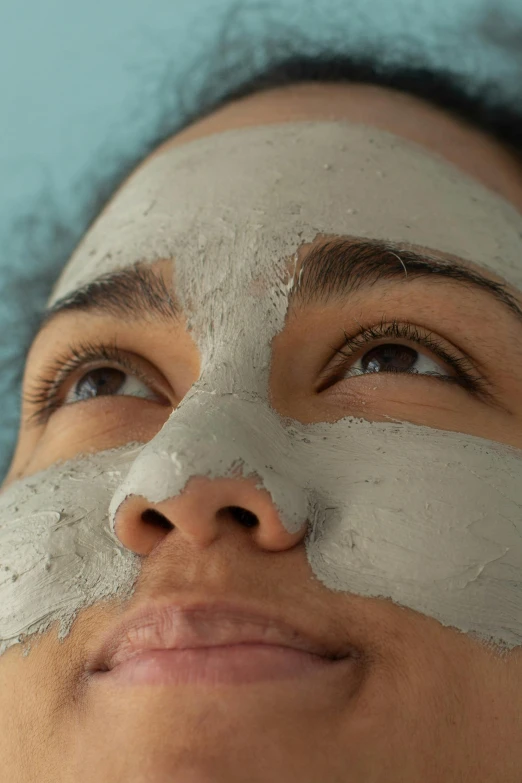 a woman with a sheet mask on her face, renaissance, hard clay, smooth defined edges, up-close, grey