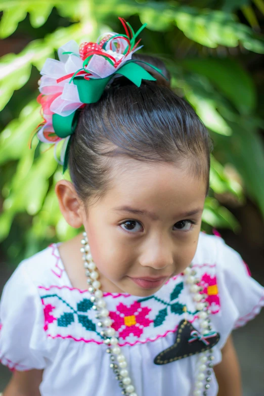 a little girl with a flower in her hair, a portrait, inspired by Pacita Abad, pexels contest winner, wearing authentic attire, wearing hair bow, tlaquepaque, square