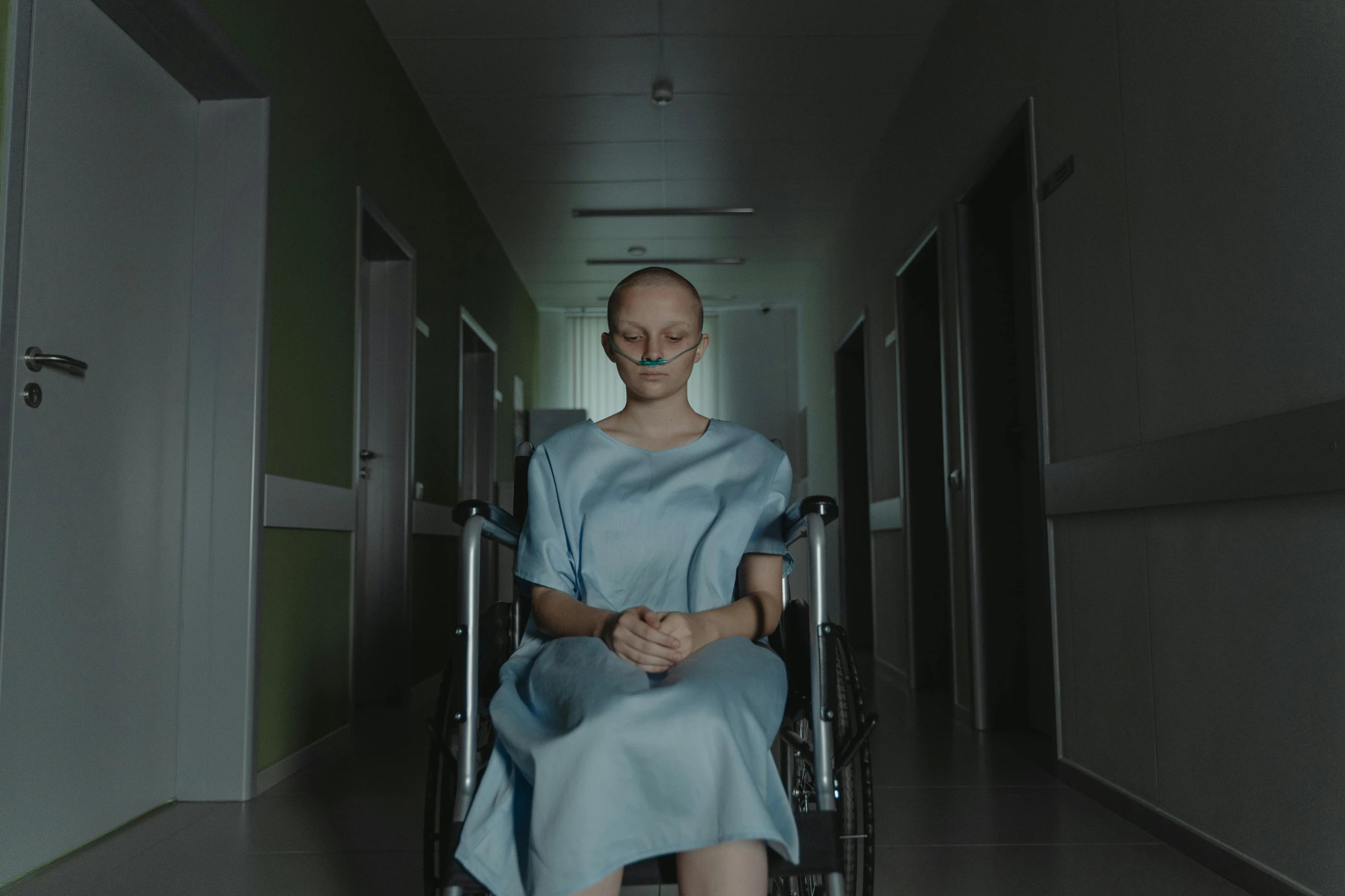 a woman sitting in a wheelchair in a hospital hallway, a portrait, pexels contest winner, antipodeans, realistic movie still, avatar image, colored photo, ( ( theatrical ) )